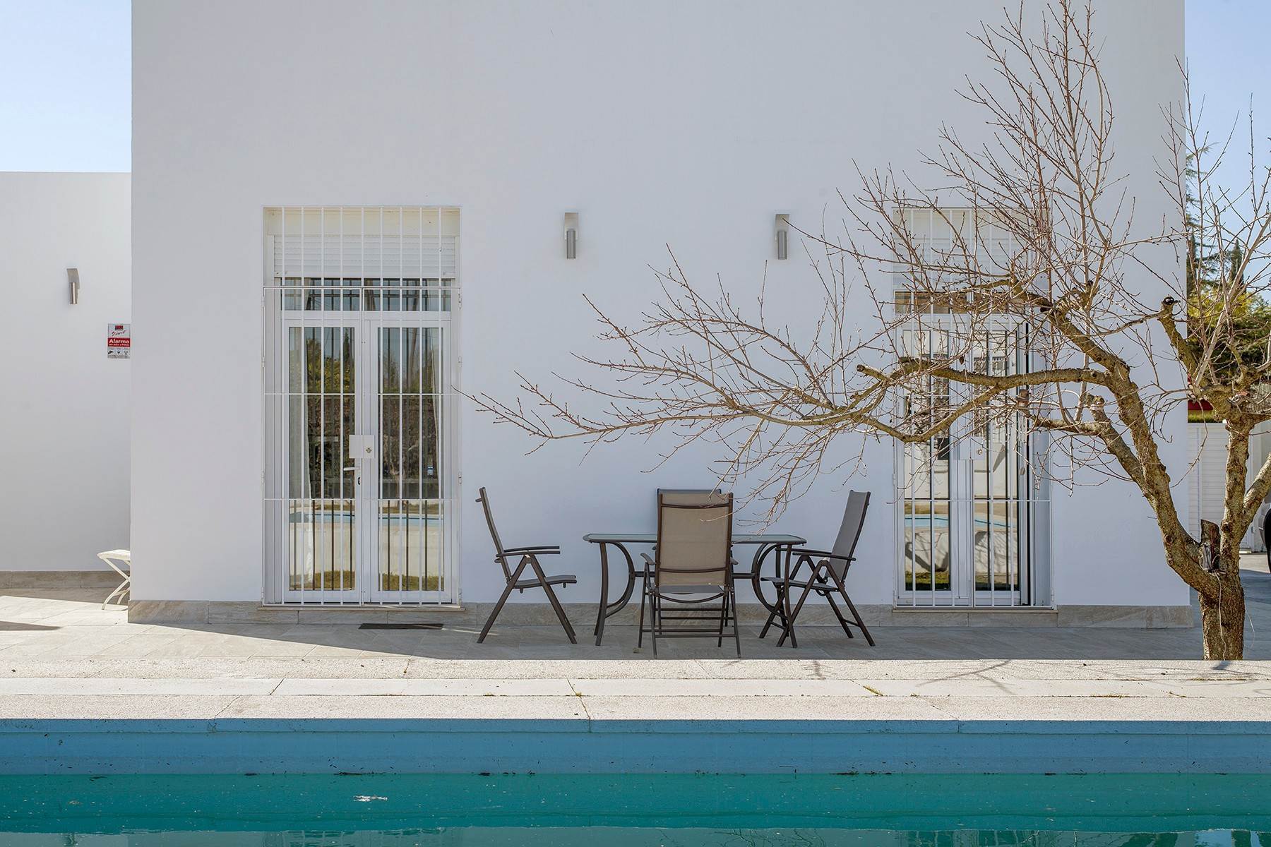 Single Family Homes for Sale at Modern house with a swimming pool and guest apartment Sevilla, Andalucia 41907 Spain
